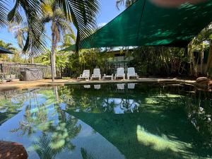 a swimming pool with lounge chairs and an umbrella at True North B&B in Horseshoe Bay
