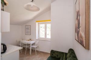 a living room with a couch and a table at Apartments and rooms by the sea Slano, Dubrovnik - 2687 in Slano +36 photos
