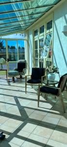 a living room with couches and tables and windows at Smart Value Premium Alpine Stay Strictly Smoke, Vape & Pet Free in Methven