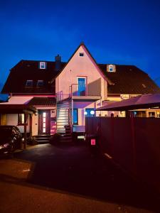 a house with a fence in front of it at Zimmer in Wattenbek in Wattenbek