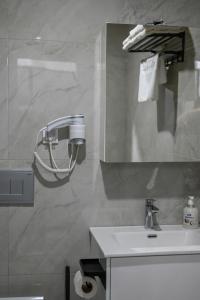 a bathroom with a sink and a mirror at Hana boutique apartments in Ulcinj +98 photos
