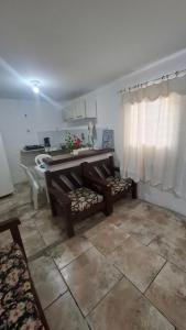 a living room with a bench and a sink at Kitnetilha in Itamaracá