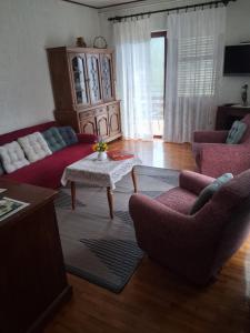 a living room with a couch and a table and chairs at Apartments with parking space Moscenicka Draga, Opatija - 7746 in Mošćenička Draga