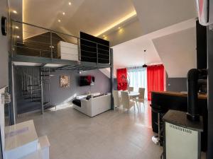 a living room with a loft bed and a dining room at Banićević APARTMANI in Đenovići