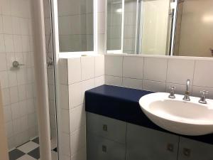 a bathroom with a sink and a mirror at Sea Eagles Unit 4 in Caloundra +7 photos