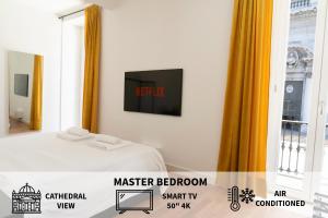a bedroom with a bed and a tv on the wall at Piazza Duomo Cathedral View in Brescia