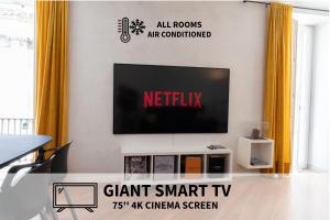 a living room with a flat screen tv on a wall at Piazza Duomo Cathedral View in Brescia