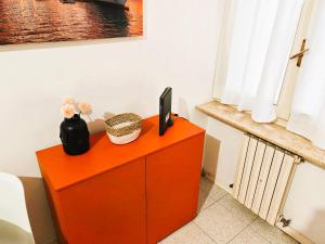 a orange cabinet with a tv on top of it at GaribaldiCentrePort in Ancona