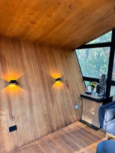 a room with two lights on a wooden wall at Amanece en la naturaleza in Mazamitla +22 photos