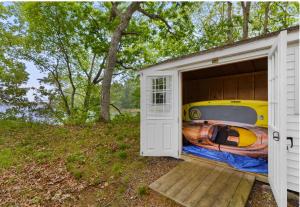 a garage with a boat inside of it at Lakefront Guesthouse w Sunrise View Dock in Stonington