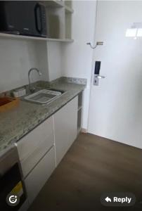 a kitchen with a counter and a sink and a door at Santa Martha-Apartment- Ocean view in Mirabel