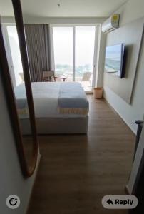 a bedroom with a bed and a large window at Santa Martha-Apartment- Ocean view in Mirabel