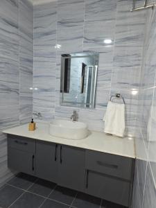 a bathroom with a sink and a mirror at Jaymorgan Villas 4 bedroomed in Nanyuki +32 photos