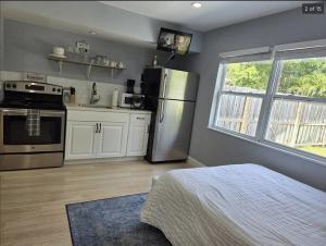 a kitchen with a refrigerator and a stove at Hideaway Steps off Atlantic Ave - Private Studio in Delray Beach