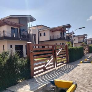 a wooden fence in front of a house at Jaymorgan Villas 4 bedroomed in Nanyuki