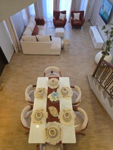 a living room with a table and a couch at Jaymorgan Villas 4 bedroomed in Nanyuki