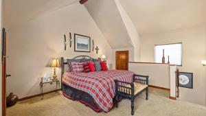 a bedroom with a bed with red pillows at The Buckeye in Red Lodge