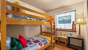 a bedroom with two bunk beds and a television at The Buckeye in Red Lodge