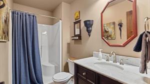 a bathroom with a sink and a toilet and a mirror at The Buckeye in Red Lodge