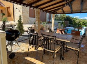 a patio with a table and chairs and a grill at Luxury Villa Pontus in Kotor