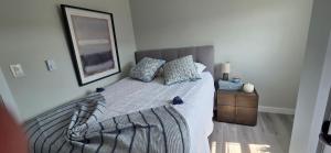 a bedroom with a bed and a picture on the wall at Down East Cabins Ltd in Tracadie