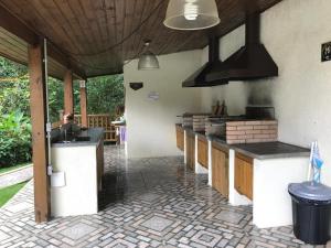 a kitchen with a counter top at POUSADA SuaCasita - 5 LAGOS in Mairiporã