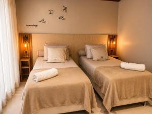 a bedroom with two beds with towels on them at Casa Naru in Atins +14 photos