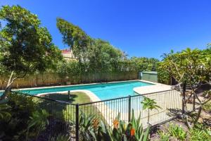 a swimming pool in a yard with a fence at Luxe Beach House at Sunshine in Sunshine Beach