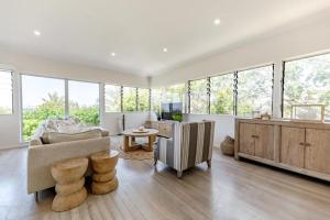 a living room with a couch and a table at Luxe Beach House at Sunshine in Sunshine Beach