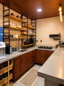 a kitchen with wooden cabinets and a counter top at Casa Naru in Atins