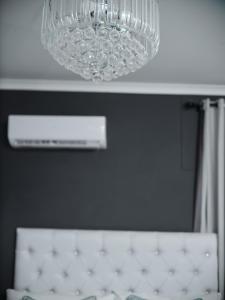 a chandelier hanging over a bed in a room at P Daisy in Rundu