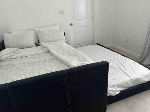a bed with white sheets and pillows in a bedroom at Cozy Apartment in Brownsville