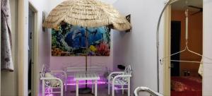 a room with a table and chairs and a painting at Kluang Seri Casa TSI in Kluang