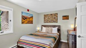 a bedroom with a bed and a window at Serenity by the Slopes in Vail