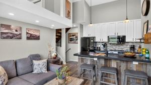 a living room with a couch and a kitchen at Serenity by the Slopes in Vail