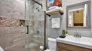 a bathroom with a shower and a toilet and a sink at Serenity by the Slopes in Vail +21 photos