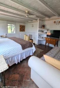 a large bedroom with a bed and a piano at Suites Santo Domingo in San Miguel de Allende