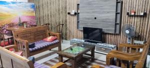 a living room with a couch and a tv at Kluang Seri Casa TSI in Kluang