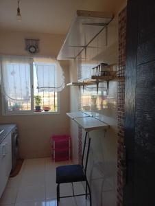a small kitchen with a counter and a chair in it at الصخيرات in Skhirat