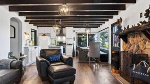 a kitchen and living room with a stone fireplace at Emerald Overlook by AvantStay in Lake Arrowhead