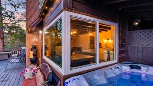 a house with a large window on a patio at Emerald Overlook by AvantStay in Lake Arrowhead