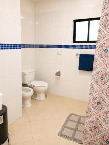a bathroom with a toilet and a window at Comfort Room 3 Adults Only in La Laguna +9 photos