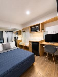 a bedroom with a bed and a desk with a computer at Aloja Rentals Mexico in Mexico City +14 photos
