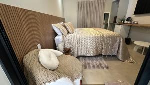 a bedroom with a bed and a couch in it at Pousada raios de sol in Chapada dos Guimarães
