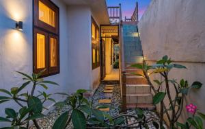 a staircase leading up to a house with plants at GWK View Boutique Hotel and Serviced Residence in Jimbaran +58 photos