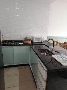 a kitchen with a stove and a counter top at Casa em Sorocaba para até 4 pessoas in Sorocaba