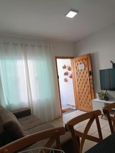 a living room with a couch and a sliding door at Casa em Sorocaba para até 4 pessoas in Sorocaba +26 photos
