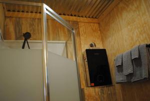 a shower with a glass door and a towel at The Perch Glamping by Rafting in Cosby +52 photos