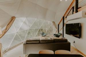 a living room with a large window in a house at The Perch Glamping by Rafting in Cosby