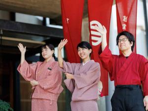 a group of three people standing in front of a flag at Yorozuya in Yamanouchi +67 photos